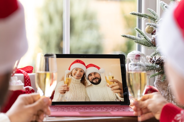Familia celebrando las vacaciones de Navidad en línea por chat de video en cuarentena. Concepto de estancia en casa de bloqueo. Fiesta navideña durante la pandemia de coronavirus COVID 19