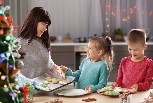 Família com saborosos biscoitos de Natal na cozinha