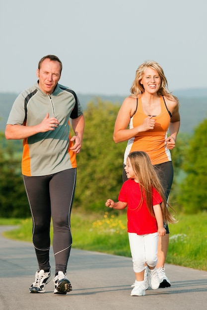 Foto familia corriendo al aire libre