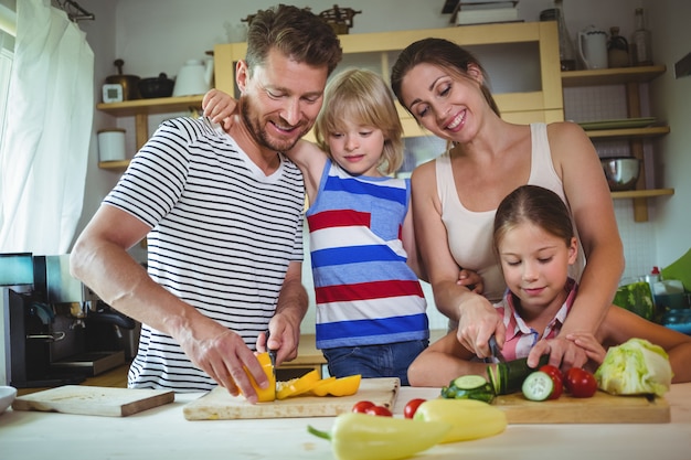 Familia cortando verduras en la cocina