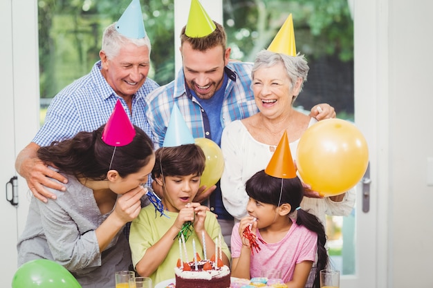 Família de várias gerações a celebrar uma festa de aniversário a sorrir