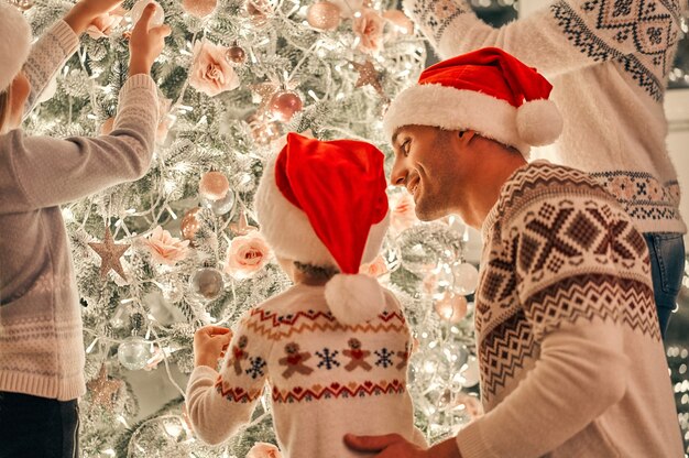 La familia decorando el árbol de navidad