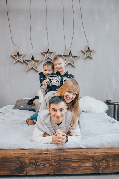 Foto família deitado em uma cama juntos no quarto