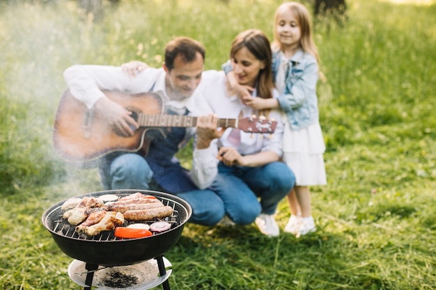 Foto família fazendo um churrasco na natureza