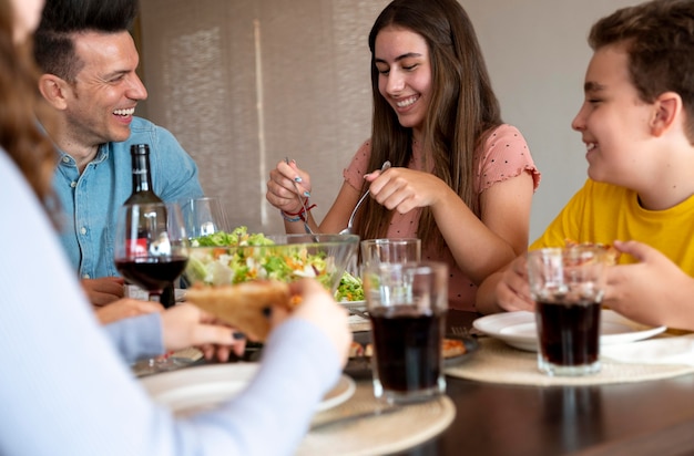 Família feliz almoçando juntos em casa