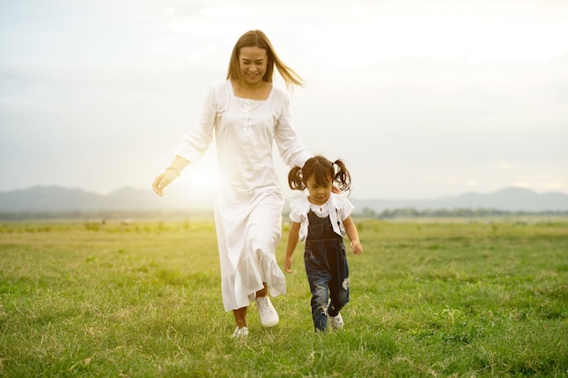 Foto familia feliz asia madre hijo hija jugando juntos al aire libre