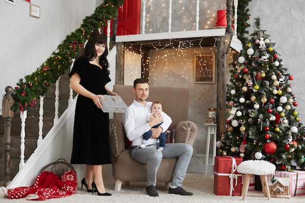 Familia feliz con un bebé celebrando la Navidad