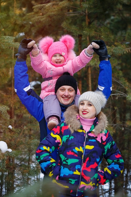 Familia feliz en bosque de invierno. pasar tiempo al aire libre en invierno