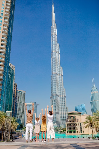 Familia feliz caminando en dubai con rascacielos