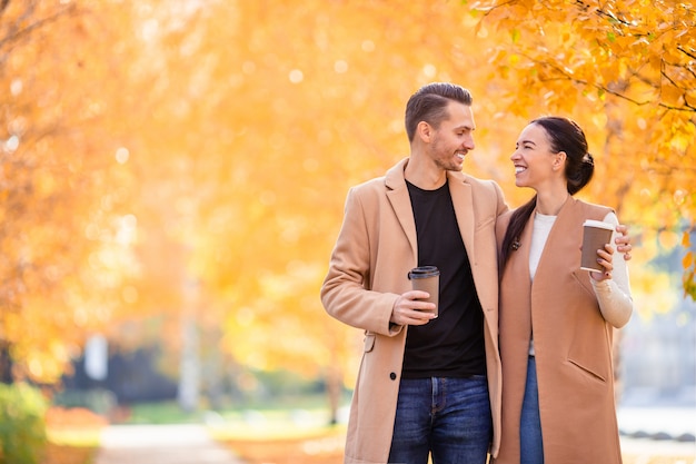 Familia feliz caminando en el parque otoño en día soleado de otoño