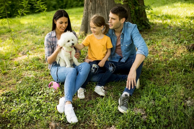 Família feliz com cachorro fofo bichon no parque