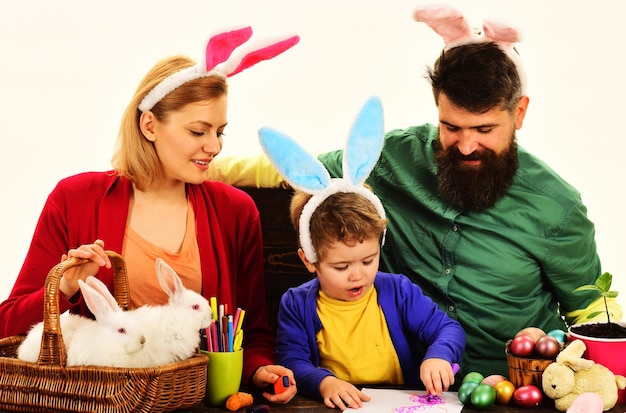 Família feliz comemorando a páscoa mãe pai e filho em orelhas de coelho nos feriados