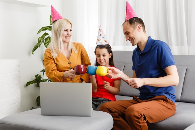 Família feliz comemorando aniversário via internet em tempo de quarentena, auto-isolamento e valores familiares, festa de aniversário online