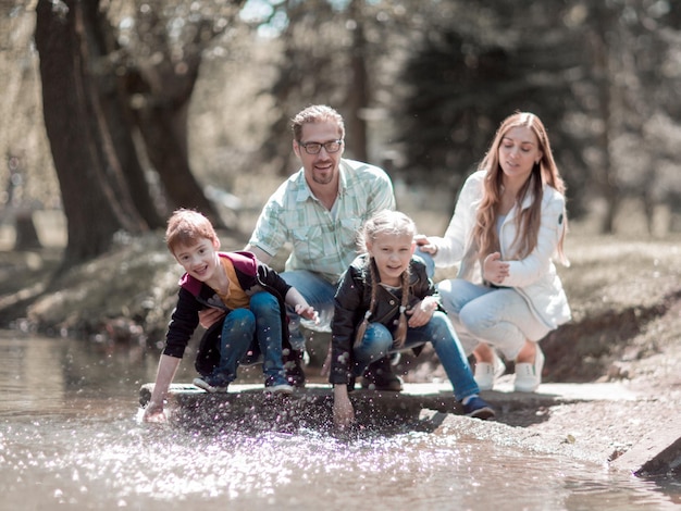 Familia feliz divirtiéndose en el lago