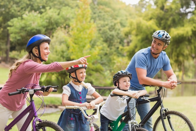Família feliz em sua bicicleta no parque