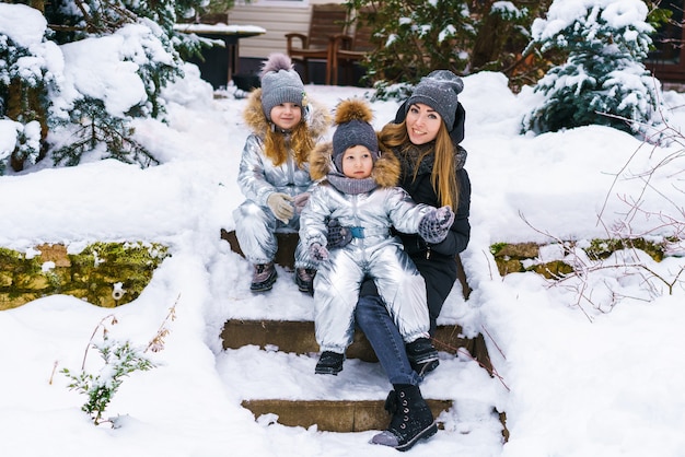 Familia feliz jugando y riendo en invierno al aire libre en el parque de la ciudad de nieve día de invierno en coágulo de invierno ...