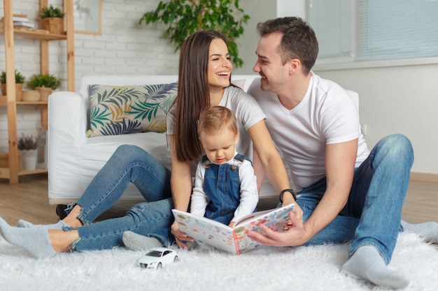 Familia feliz leyendo un libro juntos