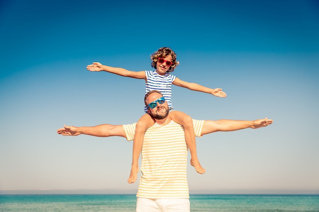 Família feliz nas férias de verão Pessoas se divertindo na praia Estilo de vida ativo e saudável