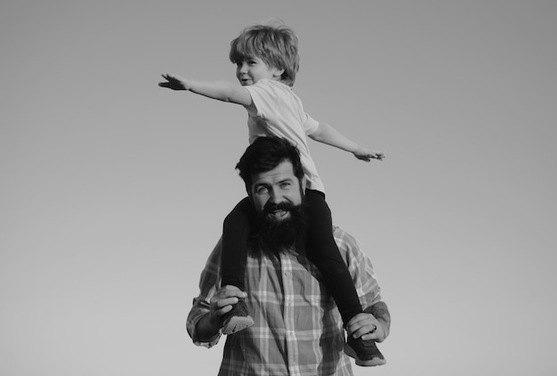 Familia feliz niño hijo abrazando a su padre contra el cielo familia viajes vacaciones día del padre feliz littl