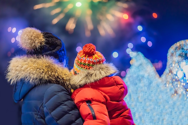 Família feliz olhando fogos de artifício no céu noturno