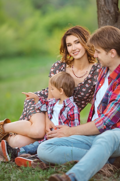 Familia feliz en un parque sobre el césped