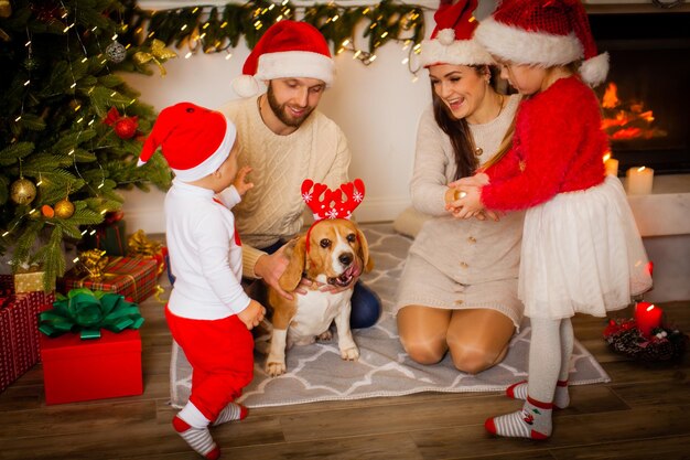 Familia feliz con perro beagle esperando la navidad