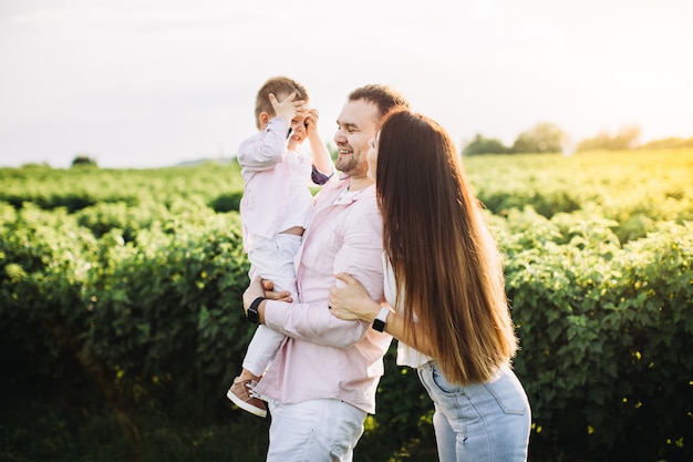 Foto familia feliz posando en un campo verde