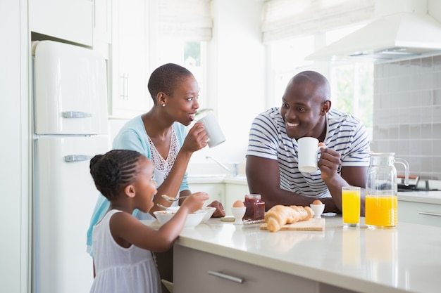 Família feliz sentado e tomando café da manhã