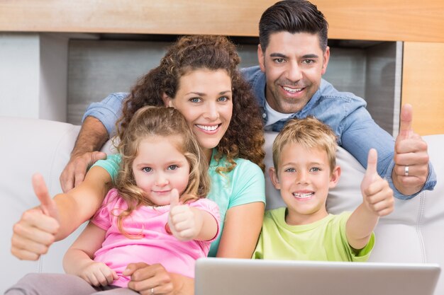 Família feliz, sentar sofá, usando, laptop, dar, polegares cima