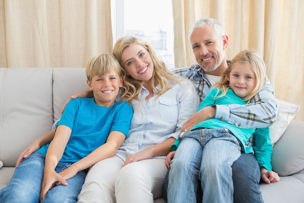 Familia feliz sonriendo a la cámara