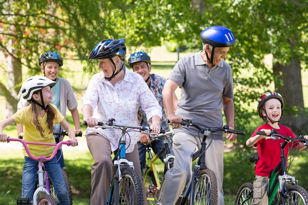 Familia feliz en su bicicleta en el parque