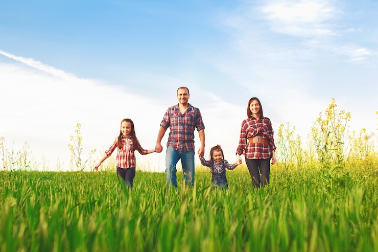 Família feliz todos juntos caminhando no campo