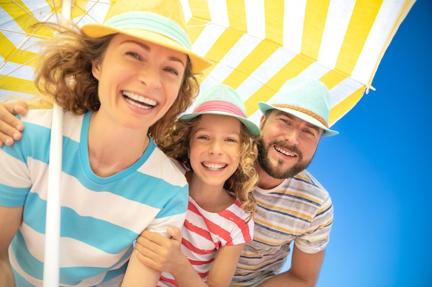 Familia feliz en vacaciones de verano Retrato de vista de ángulo bajo de gente feliz contra el fondo del cielo azul