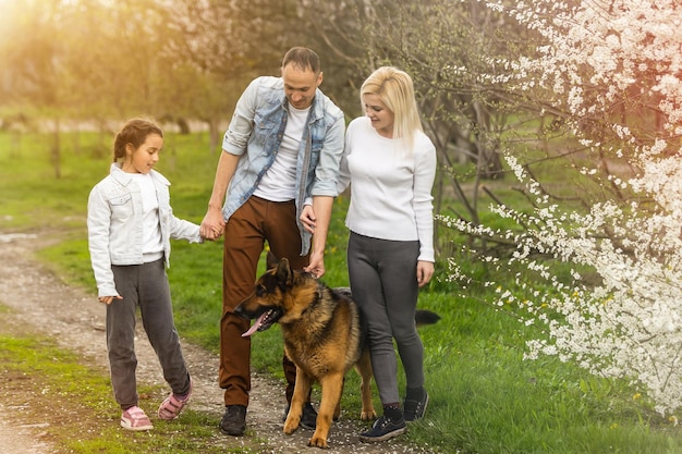 Família jovem com crianças e cachorro se divertindo na natureza