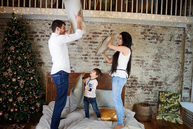 Una familia joven en el apartamento decorado para Navidad.