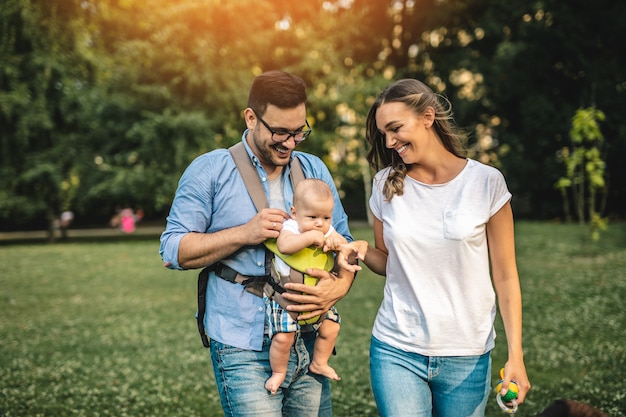 Familia joven feliz disfrutando juntos en el parque.