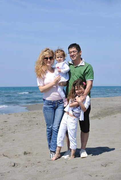 familia joven feliz divertirse y vivir un estilo de vida saludable en la playa