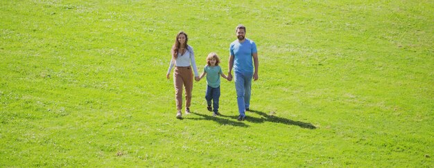 Familia joven con niño divirtiéndose en la naturaleza felicidad y armonía en la vida familiar banner panorama wi