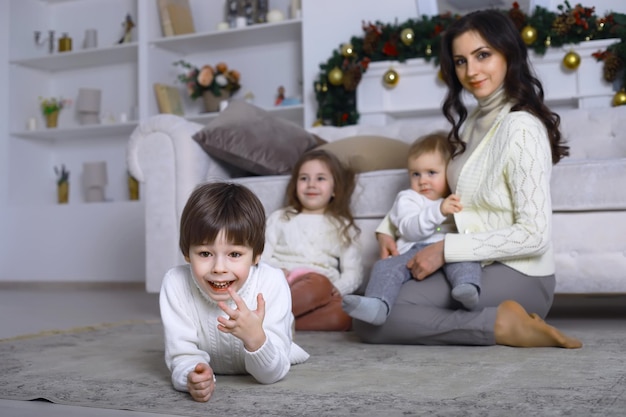 Una familia joven con niños decora la casa para la fiesta de Nochevieja Esperando el nuevo año