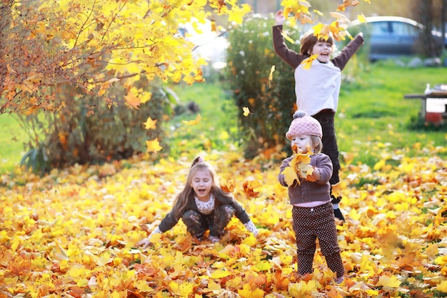 Familia joven en un paseo por el parque de otoño en un día soleado. Felicidad de estar juntos.