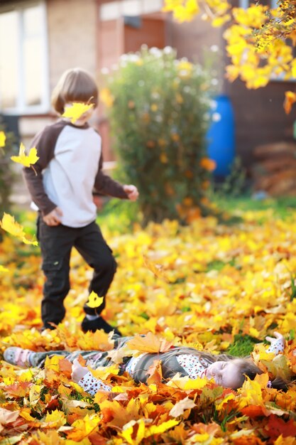 Foto familia joven en un paseo por el parque de otoño en un día soleado. felicidad de estar juntos.