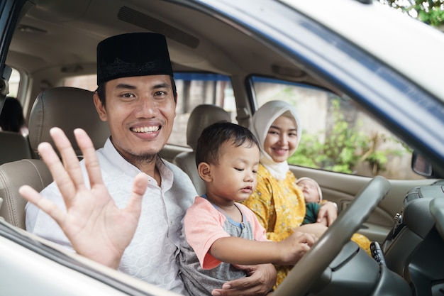 Familia musulmana viaja en coche durante la celebración de eid mubarak