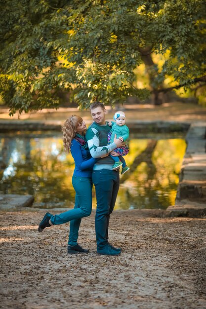 Família na floresta no fundo de um pequeno lago