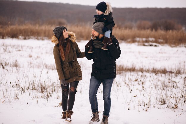 Família no inverno na floresta com filho