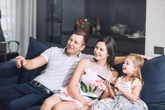 Familia padre madre hija juntos hermosa y feliz en casa juntos en el sofá