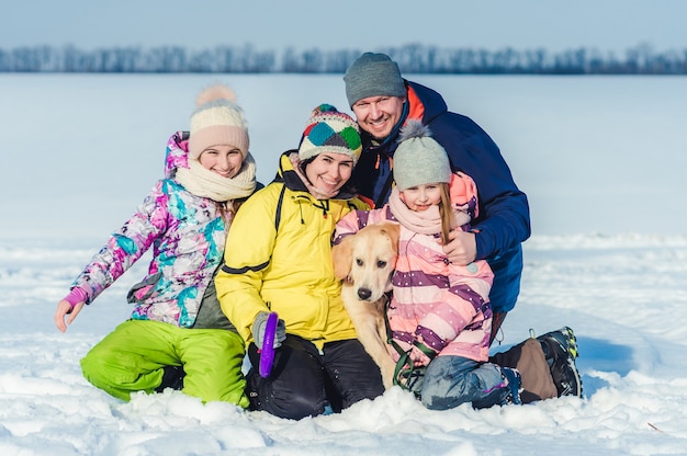 Familia con perro en paseo de invierno