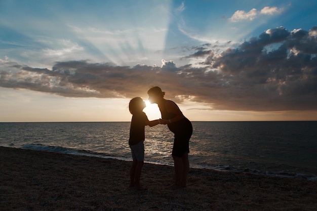 Familia, en la playa, siluetas, de, gente, contra, el, ocaso, gente, cogidos de la mano