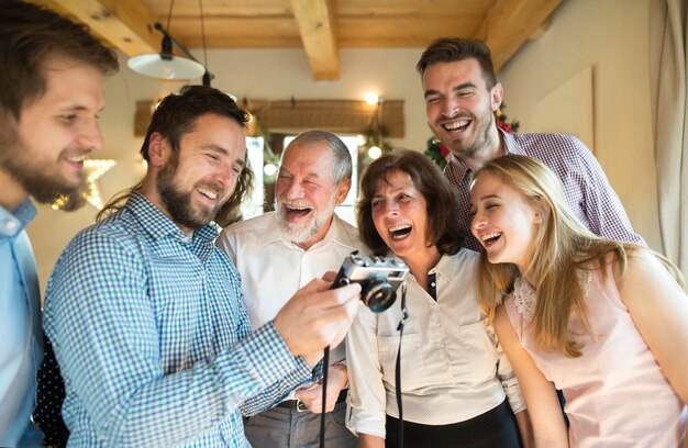 Foto família rindo olhando para a câmera