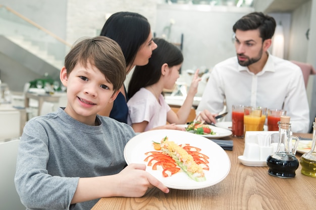 Família sentada no conceito de almoço em restaurante