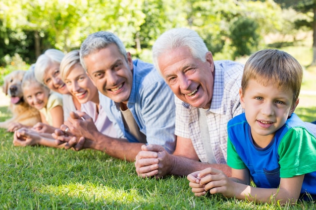 Familia sonriente mirando la cámara con su perro